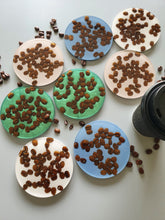 Load image into Gallery viewer, Fun coffee lover set of coasters with organic coffee beans encased in resin with a coloured background to brighten up your daily coffee while pairing as functional art. Created by Katherine Looke, Owner of Mylittleresinhobby.
